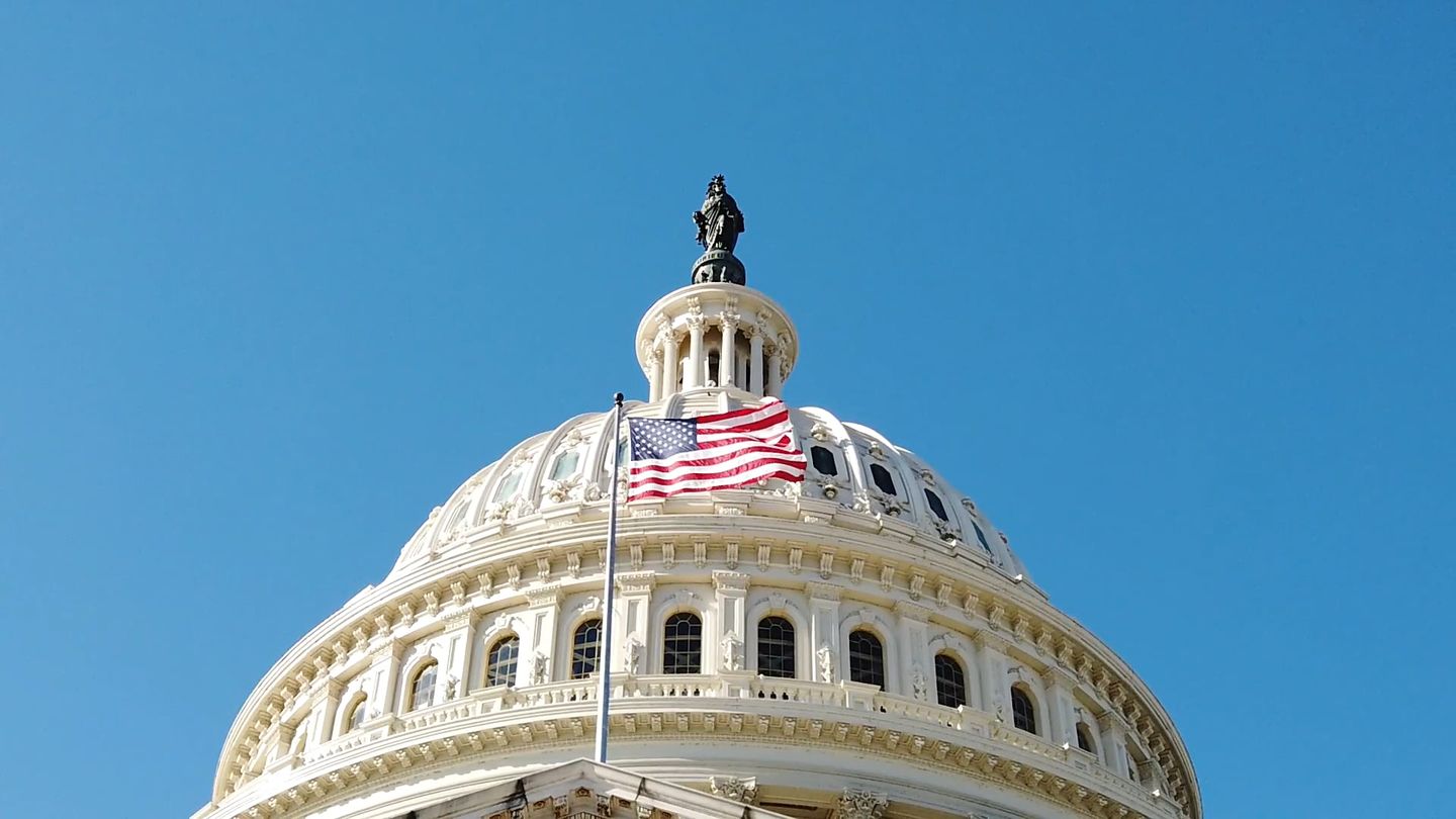 The American flag before the United States Capitol dome